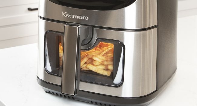 Air fryer with fries cooking inside
