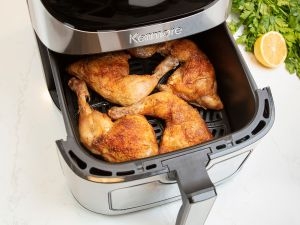 Kenmore 12-in-1 air fryer with cooked chicken legs in the basket