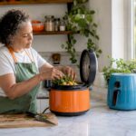 Woman using smart pressure cooker in kitchen